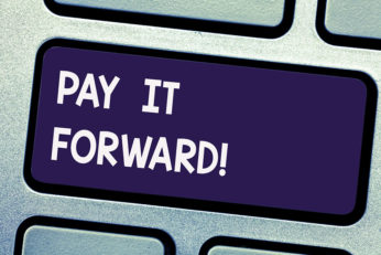 Writing note showing Pay It Forward. Business photo showcasing Do the payment a certain amount of time after purchasing Keyboard key Intention to create computer message pressing keypad idea